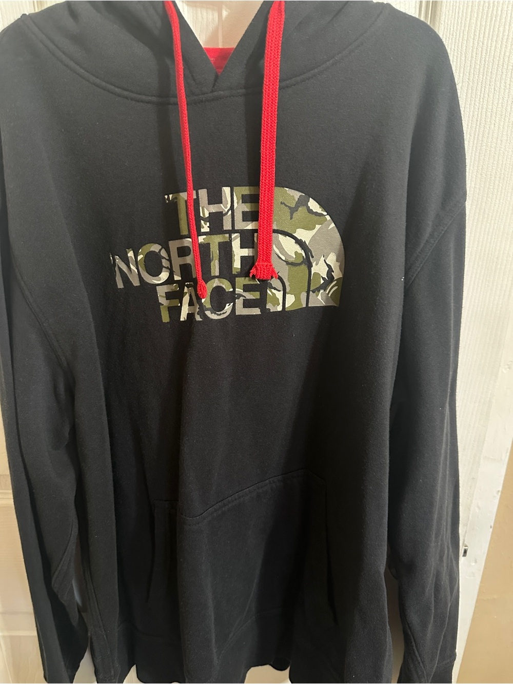 The North Face Black Hoodie with Camouflage Logo and Red Drawstrings